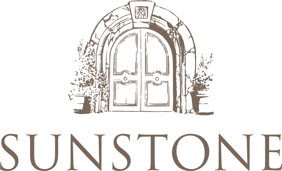 Sunstone logo featuring a stone arched doorway with plants on either side and 'SUNSTONE' below.